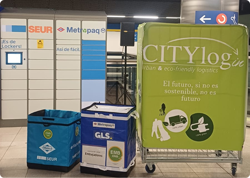 Madrid metro urban logistics: CITYlogin logistics container, SEUR parcel lockers and delivery boxes inside a Madrid metro station supporting sustainable last-mile delivery.